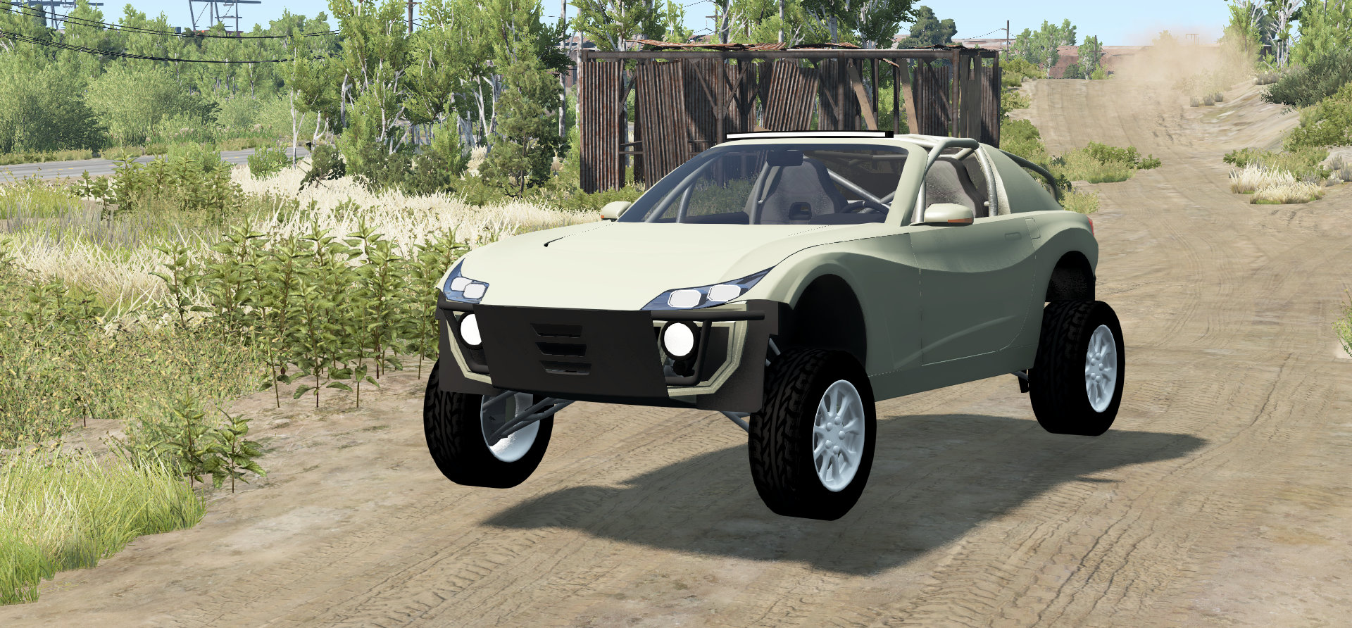An off-road version of the R21 going over a jump on a dusty trail in a grassy area.